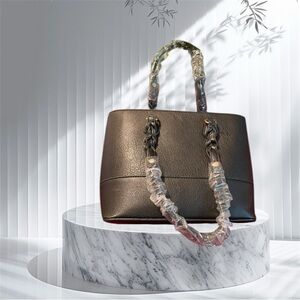 NWOT UNBRANDED BLACK HANDBAG TOTE. HAS PARTLY BRAIDED 9” STRAP GOLDTONE HARDWARE